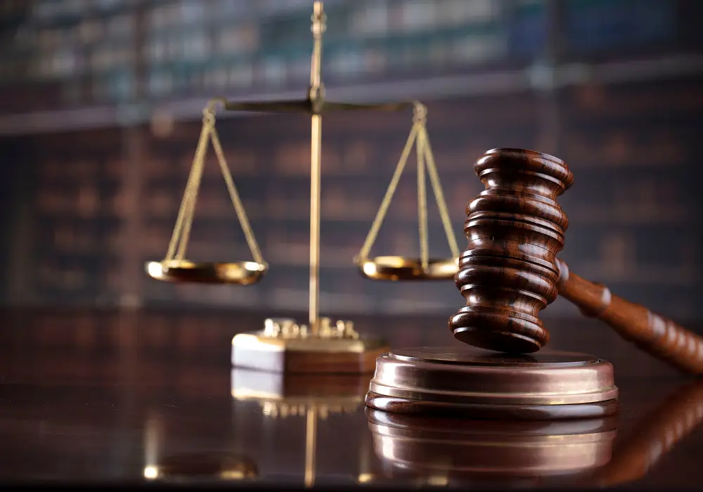 Law office setting with scales of justice and gavel